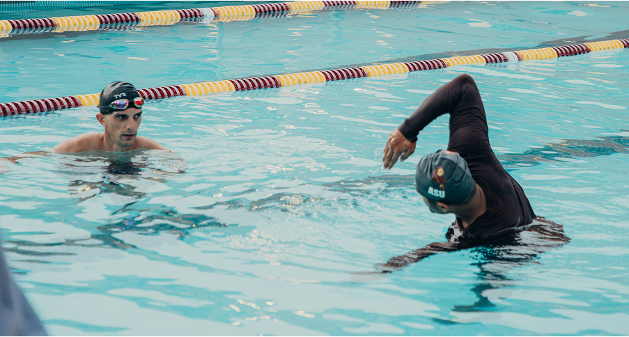 Coach teaching swimmer